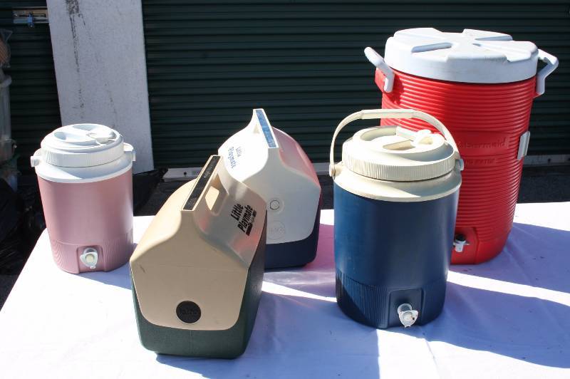 Assorted coolers and large water jugs