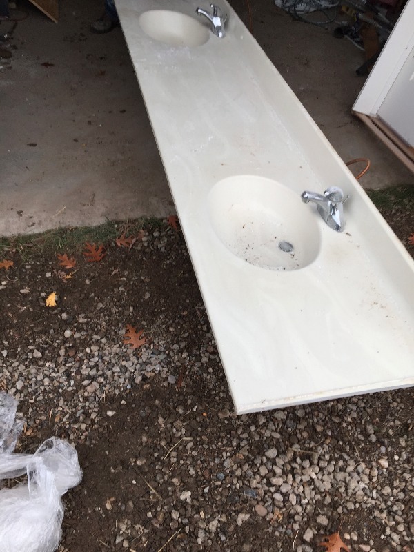 lot 12 image: Long bathroom dual sinks mounted in countertop with back splash