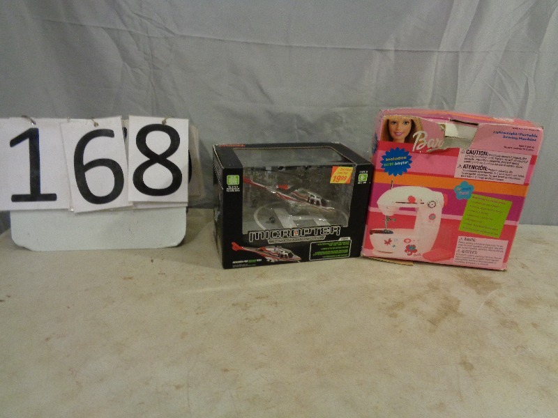 lot 168 image: New Helicopter and Barbie Sewing Machine
