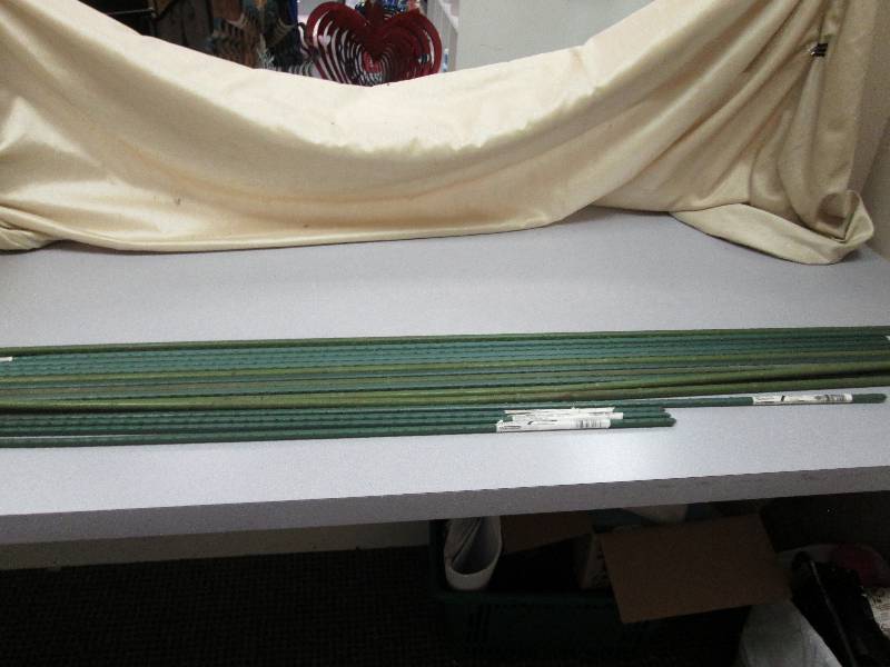 15 garden stakes of different lengt...