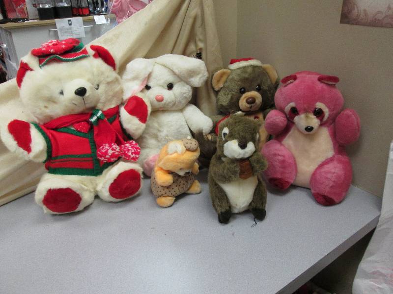 stuffed animals all displayed in pi...