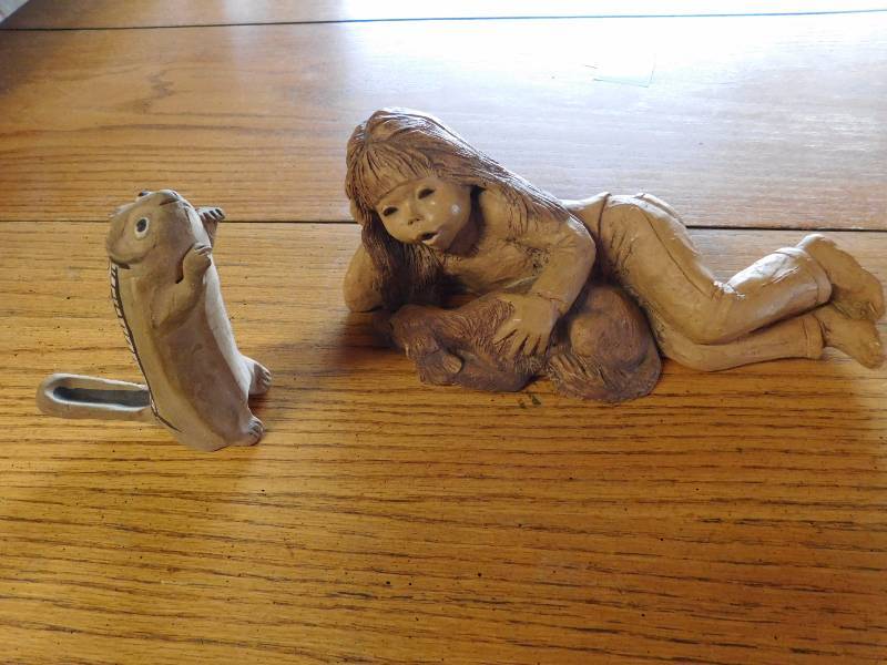 two decor items, chipmunk and a girl with her dog