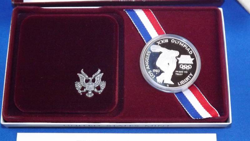 1983 Silver Olympic Dollar coin, in box with papers