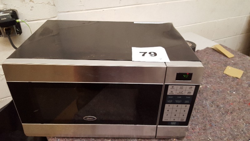 lot 79 image: Oster 1.1 cu. ft. Stainless Microwave