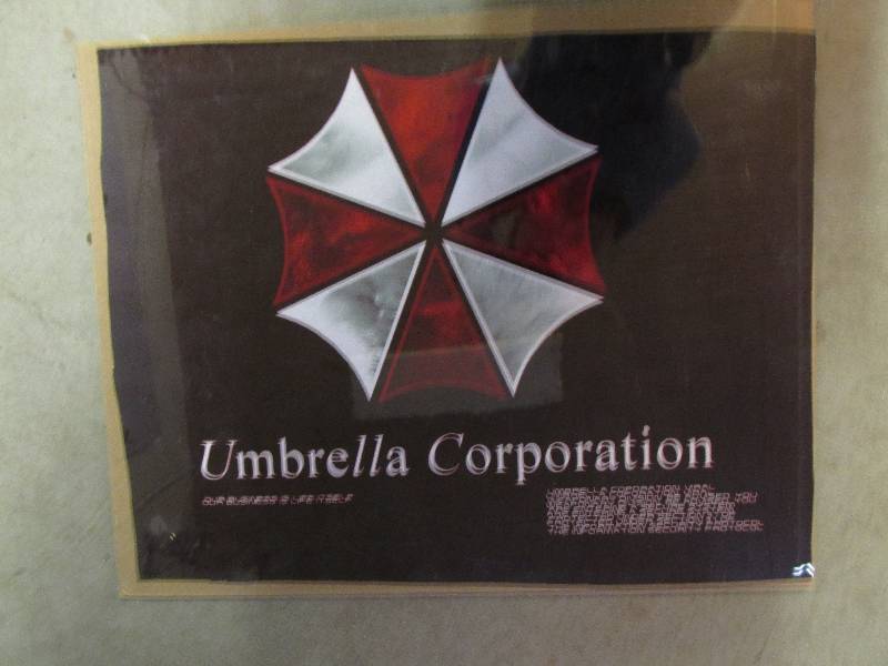 lot 25 image: umbrella corporation poster with pl...