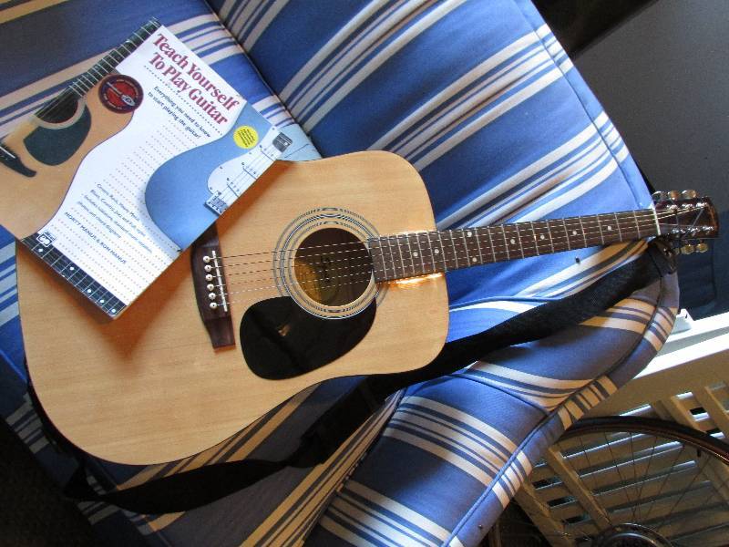 lot 38 image: Fender guitar and guitar book - alm...