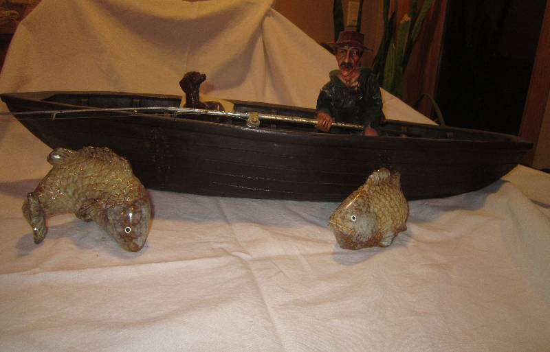 lot 34 image: Fishing Boat 29L x 7 W with Fisherman, Bucket of fish, Dog, Oar, and Pair of Ceramic Fish