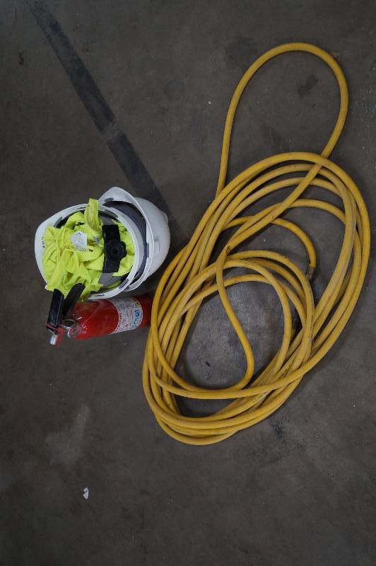 Air hose, fire extinguisher, and 2 hard hats and vests