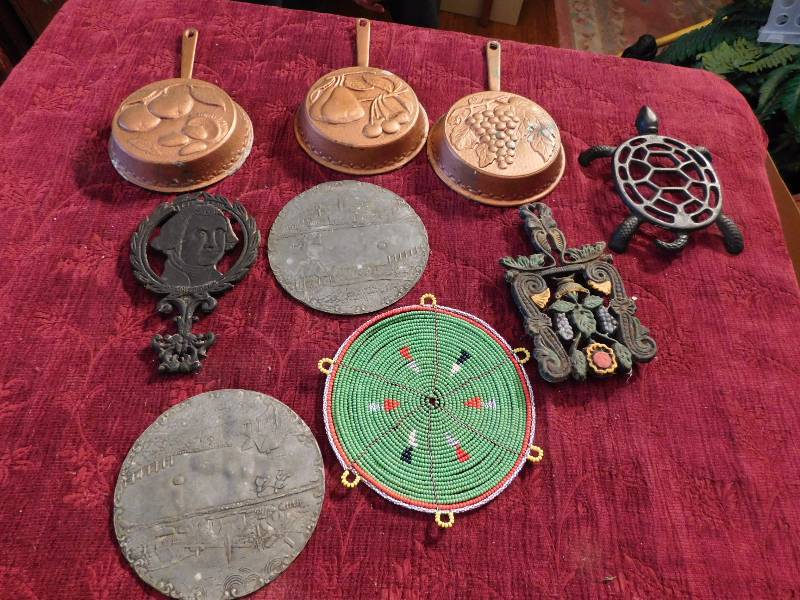 lot 46 image: several metal decorative items wall hangings trivets and more