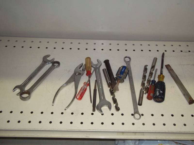 Lot of tools with drill bits, pliers and wrenches