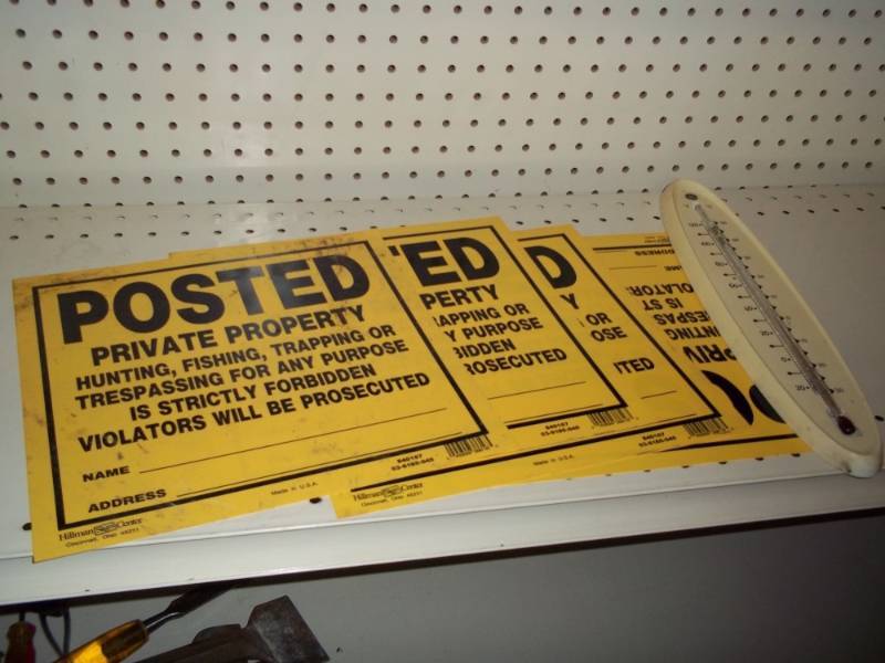Posted signs with vintage thermometer