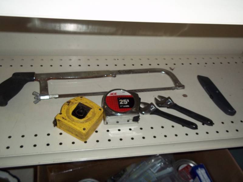 Lot of tools with hacksaw and tape measures