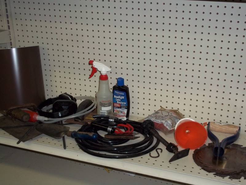 Shelf lot with saw blades, funnels, tubing, headlight cleaner, brown flashing