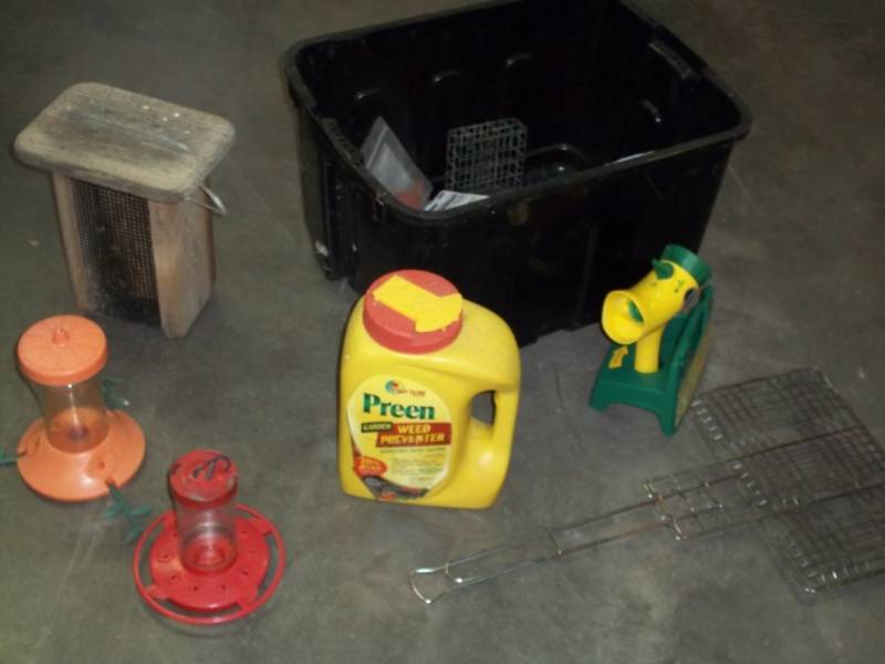 Outdoor lot with humming bird feeders, suet feeder with tub