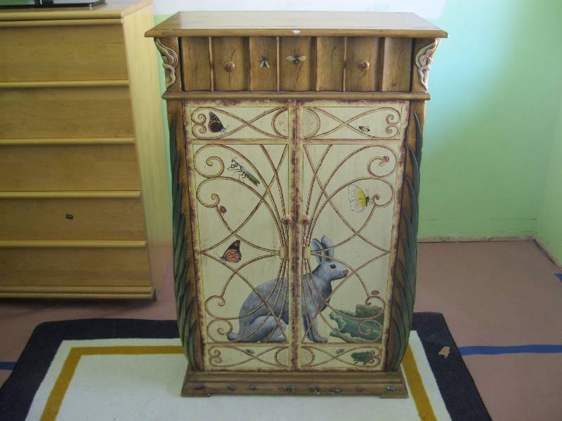 lot 18 image: Very Cool Ornate Wine Cabinet. Very Detailed With Raised Palm Tree Like Sides And Art. 48x31x18