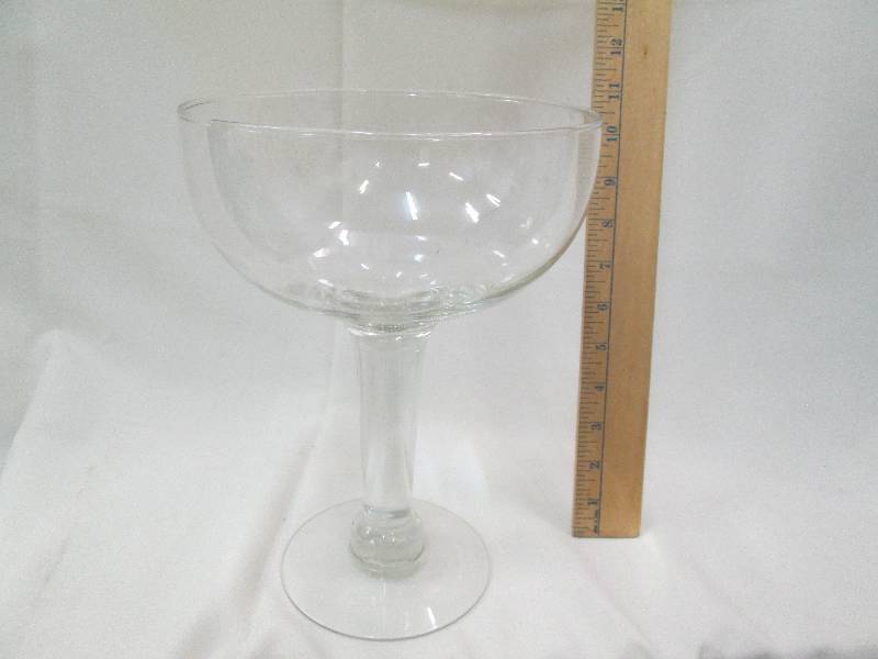 Clear glass wine- glass shaped vase...
