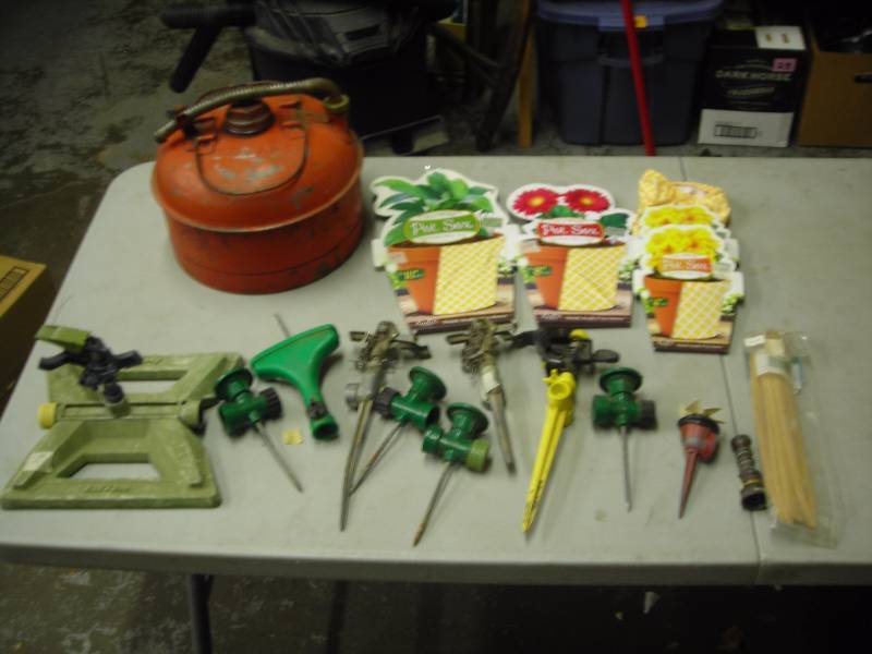 lot 28 image: Assortment Of Sprinklers, Plant Pot Covers, Small Gas Can