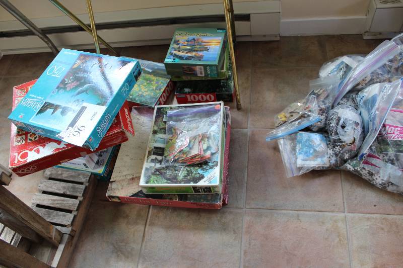 lot 96 image: Puzzle Lot includes multiple puzzles of various sizes and pictures
