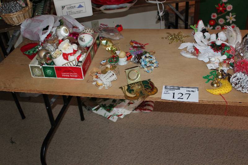 lot 127 image: Table Lot includes various Cristmas tree ornaments.  Does NOT include the table.