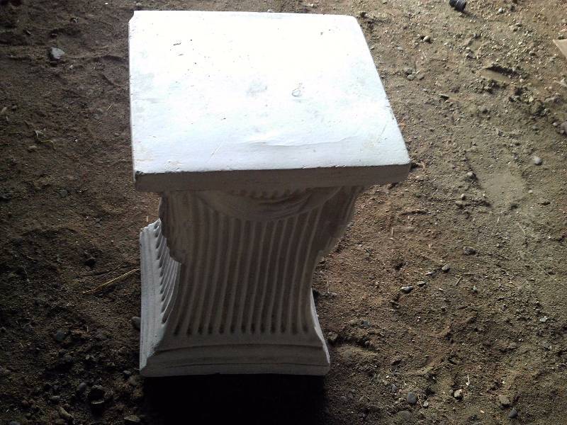 white plaster flower pedistal