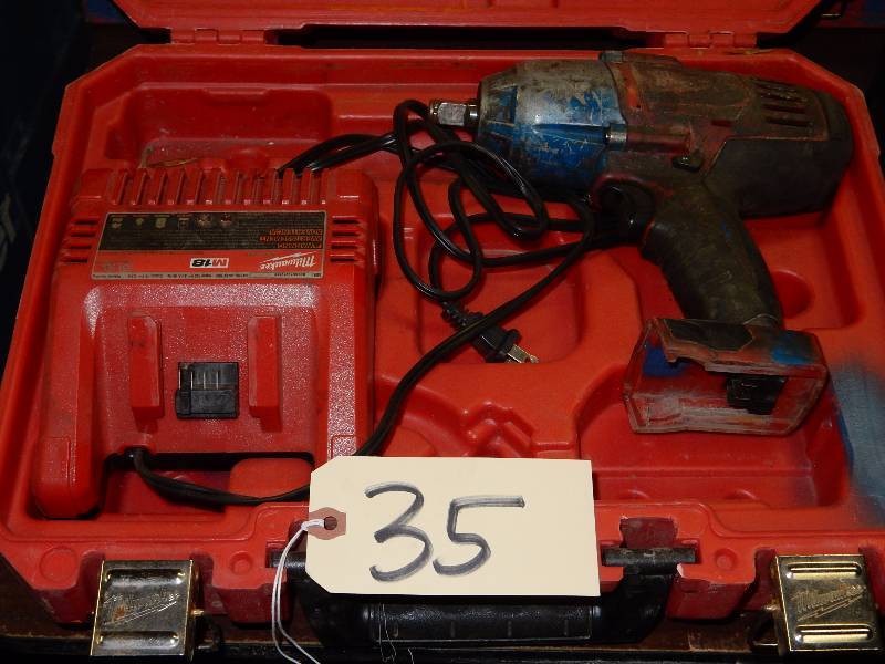 lot 35 image: Milwaukee 12 in Cordless impact wrench. Charger, but no batteries