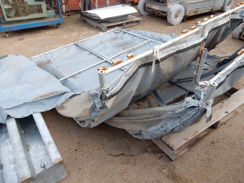 lot 199 image: 2 piece job  site tent.. Two parts fit together to form an igloo type of structure. Has aluminum frame with zipper doors and windows.. It might need some other parts to complete, but looks like most of it is there.