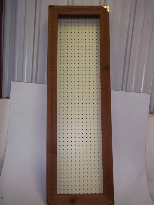 Display case with pegboard back and hinged door, missing glass