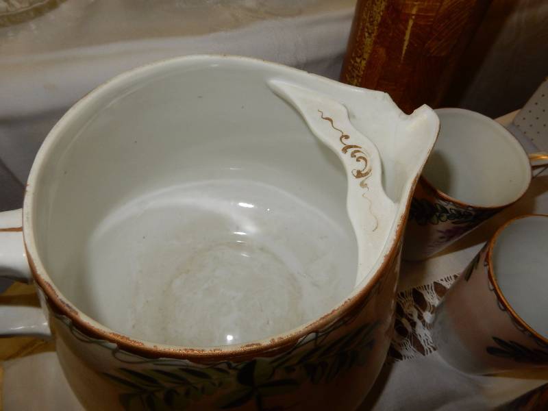 VERY OLD pitcher with 5 matching cups.. Nippon China.. Has a chip on the spout as shown.