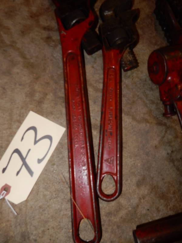 2 pipe wrenches.. 16in x 14in.. Tool with chain.. Look to be some type of cranking device.. Not sure.. Look at the close-up.