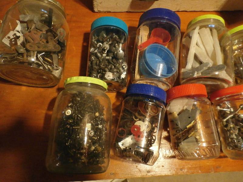 flat of jars with hardware in them.