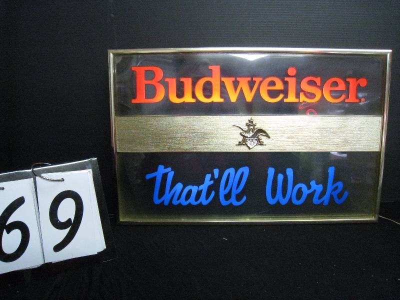 lot 69 image: Budweiser Thatll Work, clear acrylic, edge lit with graphics, perfect for the garage or workshop Thatll Work now its time for beer