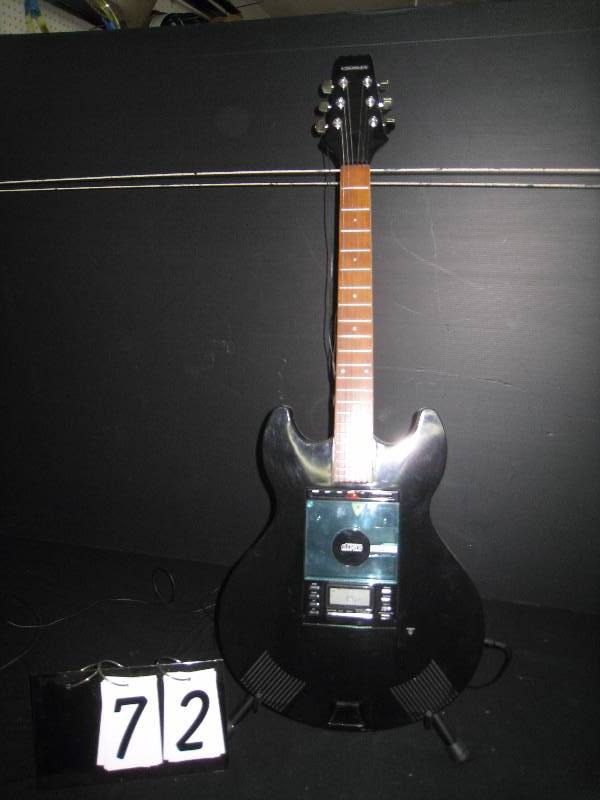 lot 72 image: Guitar shaped CD player  radio with stand, looks like authentic guitar with stand, tested - works great, auxillary speaker ports and built in speakers