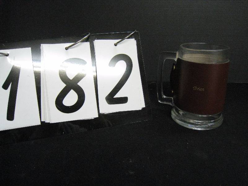 lot 182 image: Glass beer mug with snap-on  removable leather sleeve embossed with Brian