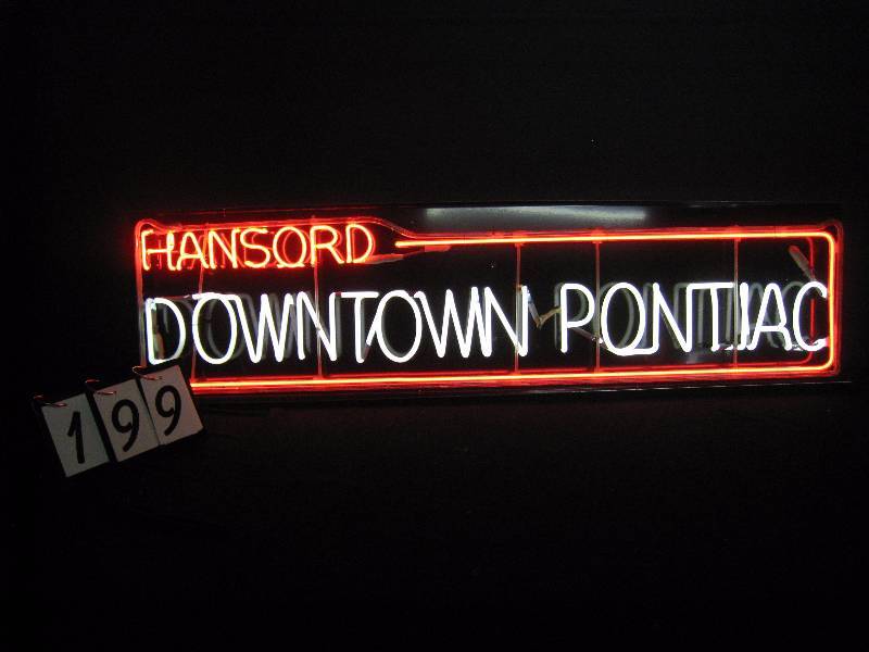 lot 199 image: Hansords Downtown Pontiac, 60s vintage glass frame window sign from Hansords Dealership, recently mounted to black aluminum window style panel with transformer
