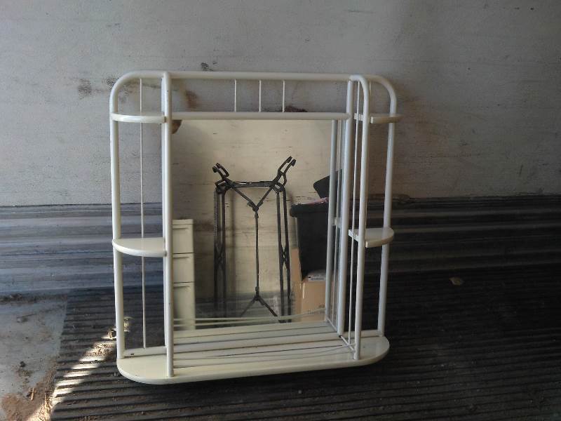 white metal wall shelf with mirror
