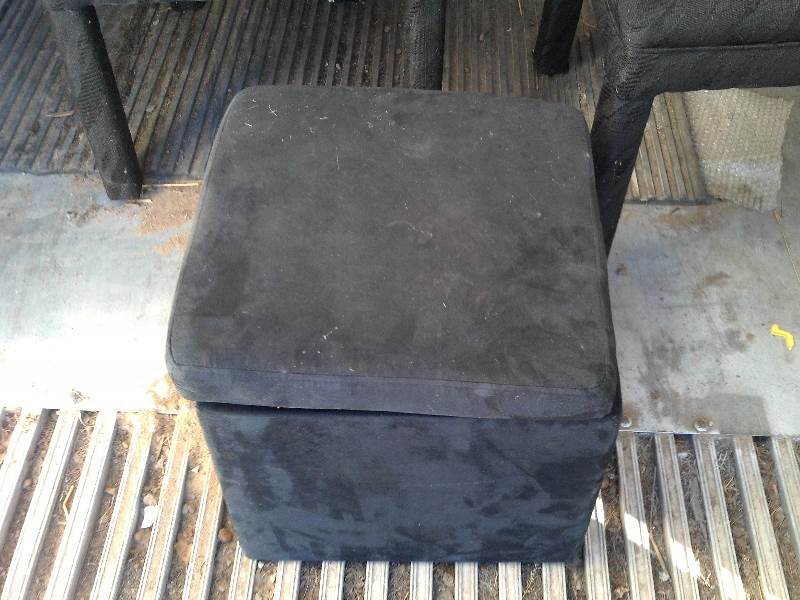 set of 4 black padded chairs and foot stool