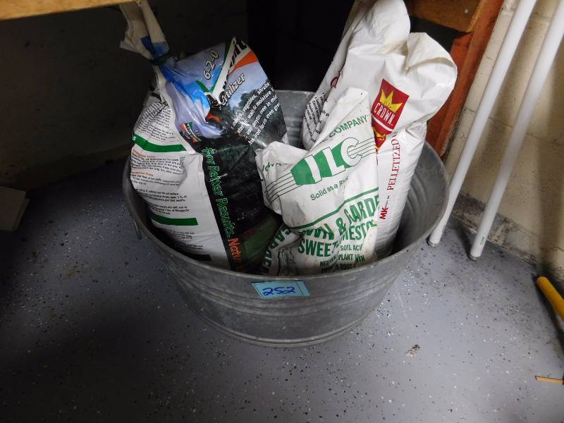 lot 252 image: 24 diameter galvanized pan and gardening fertilizer bags are included