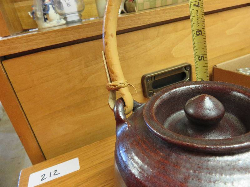 two teapots with wicker handles