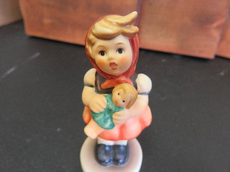 Little girl with baby figurine (1967)