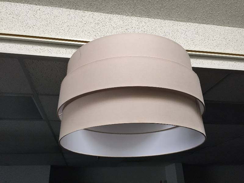 Over sized beige lampshade light with new hanging light perfect for a business or vaulted ceilings