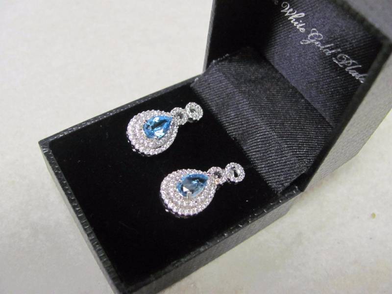 lot 106 image: 14 Karat White Gold Plated Blue Topaz Teardrop,Studded Gem Earrings