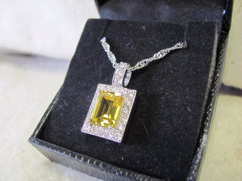 lot 111 image: 14 Karat Gold Plated Amber Brown Pendant