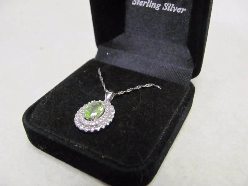lot 146 image: Sterling Silver Oval Green and Crystal Pendant