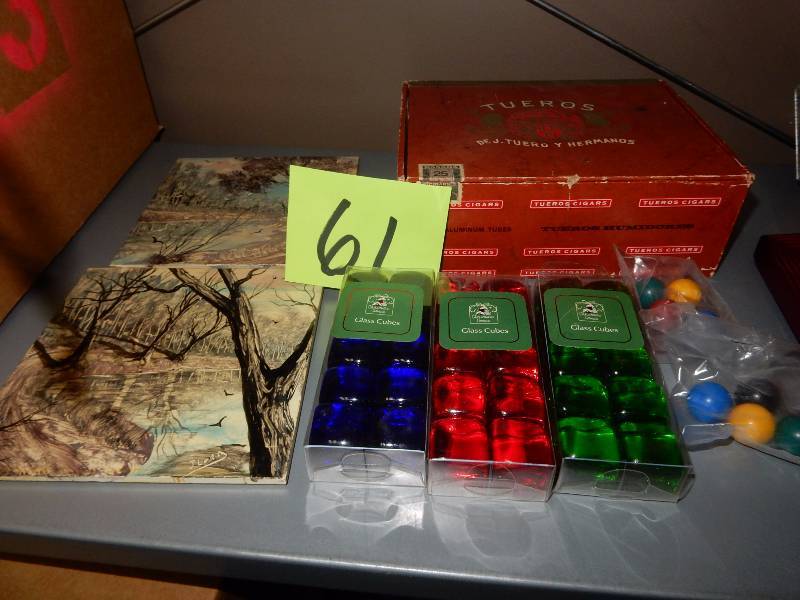 lot 61 image: Misc. Decorative items.. 3 boxes of glass cubes, 2 outdoor theme trivets, Marbles, Cigar Box.. Habana cigars.. Stamped Canada.