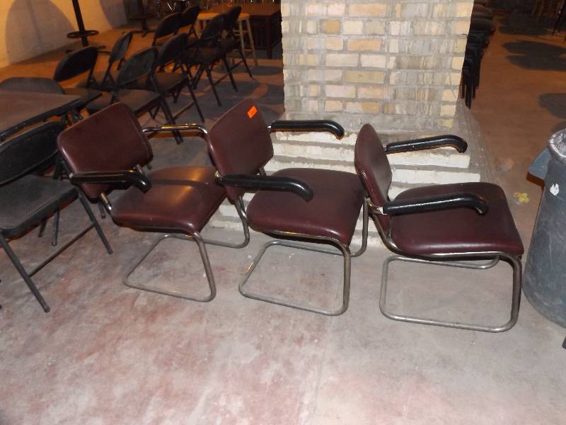 3 metal arm chairs with brown vinyl seat and back, 1 arm pad missing.