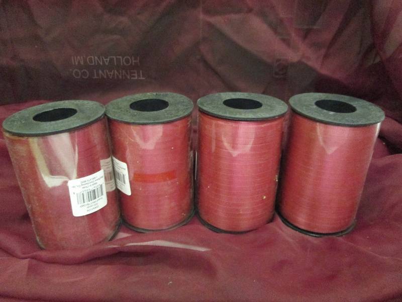 4 rolls burgandy curling ribbon...