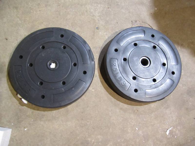 lot 61 image: Pait of 25 lb weights, one edge is ...