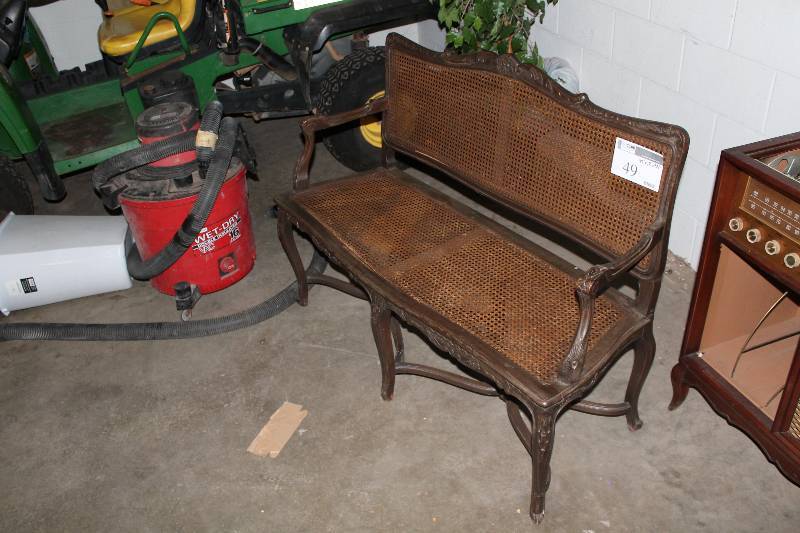 Brown Indoor Wicker Loveseat with Ornate Wooden Frame, Legs and Armrests
