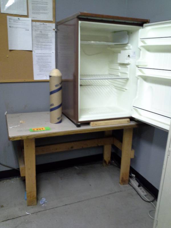 Many refrigerator and wooden table