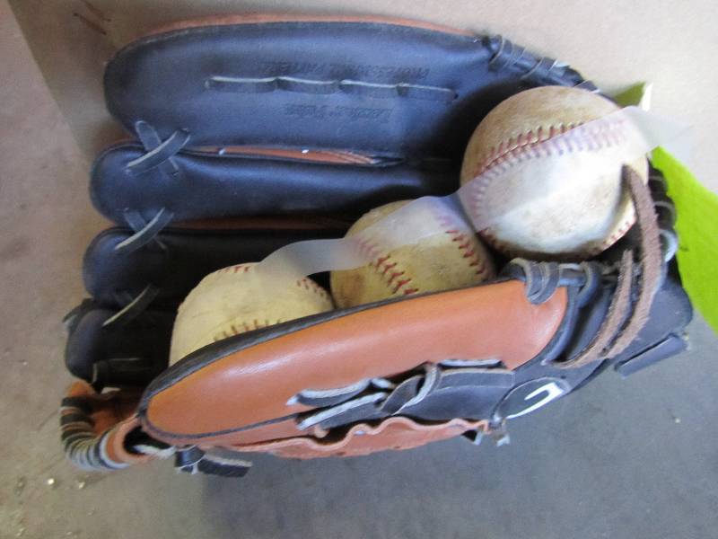 baseball glove with 3 baseballs ...